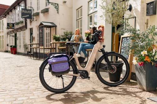 Modern white e-bike in front of cafe