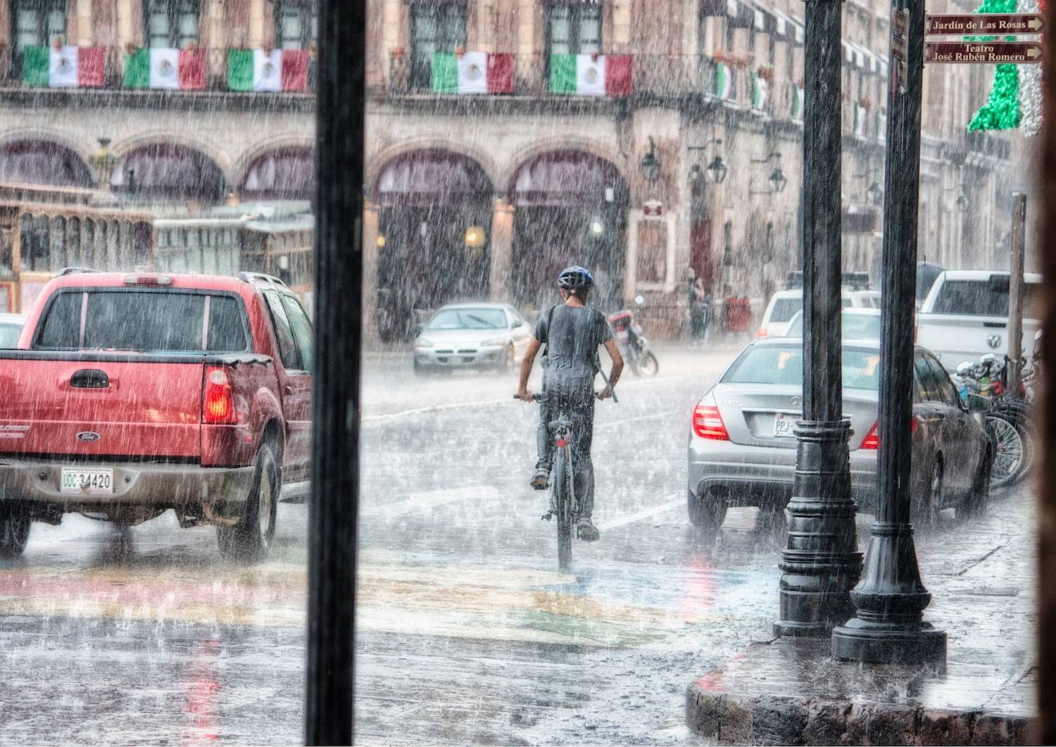 Man on a bicycle in the rain