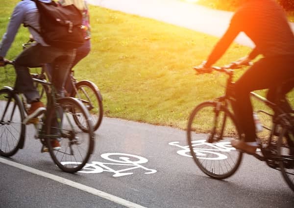 Three cyclists ride on cycle path