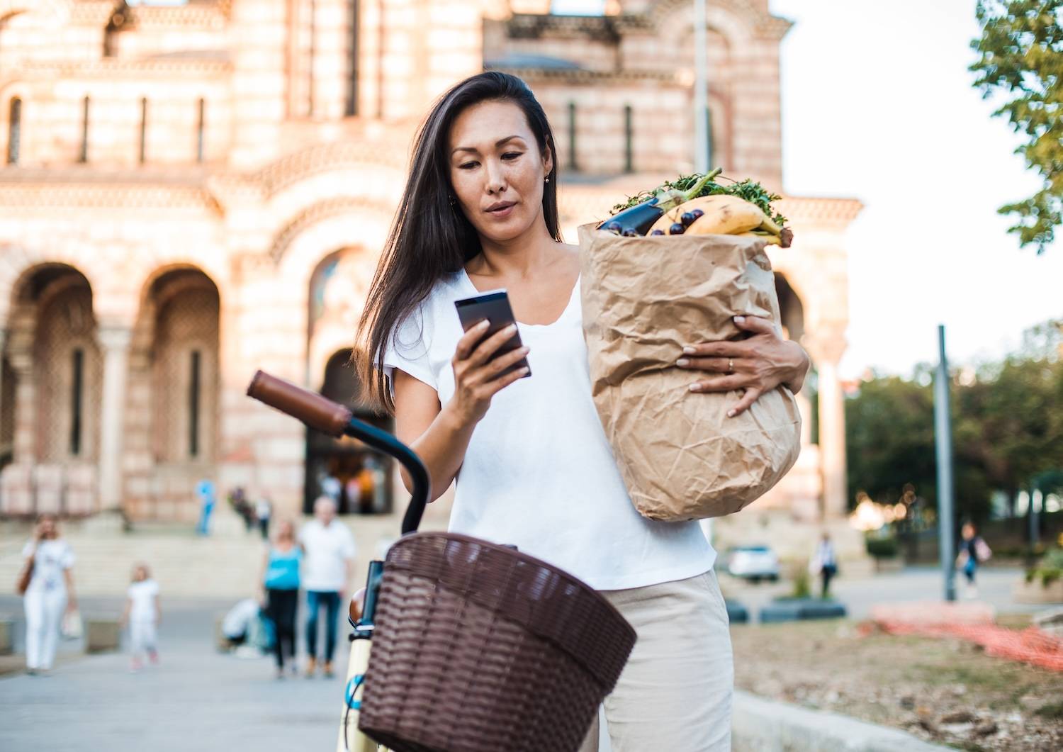 Woman with shopping bag and bicycle