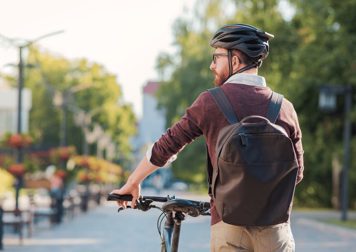 Man with bicycle and bicycle helmet