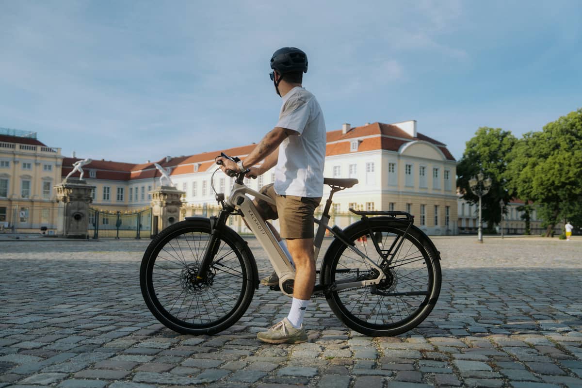 Man with Kalkhoff bike in front of building