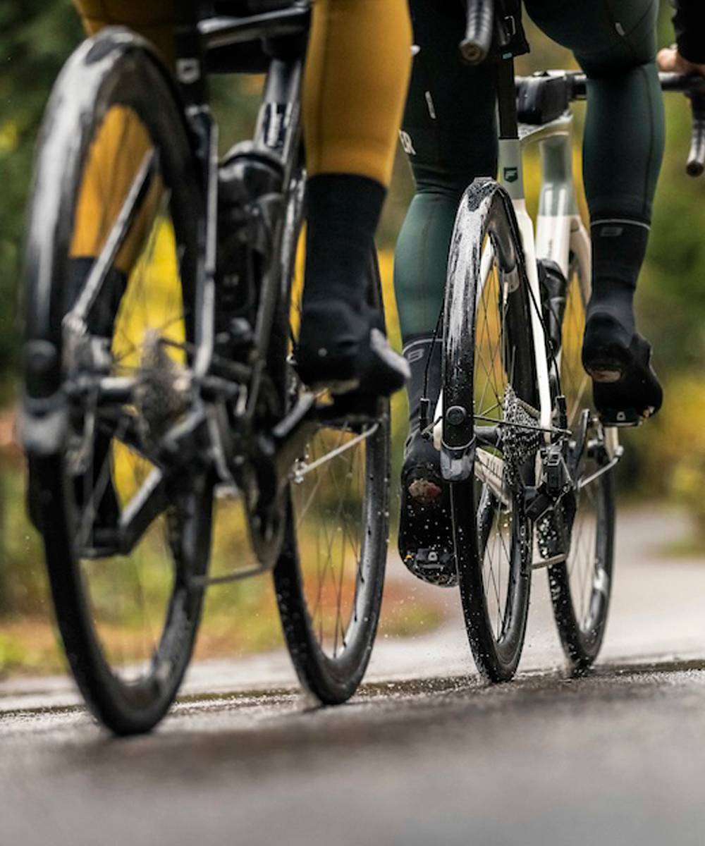 Two racing cyclists in the fall