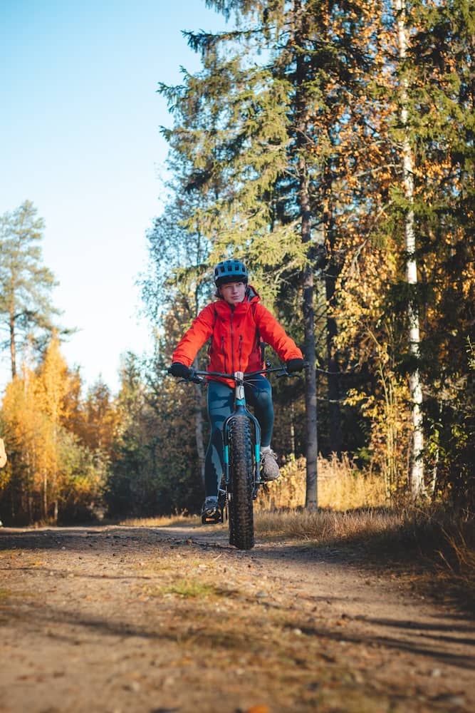 Man with mountain bike in the autumn forest