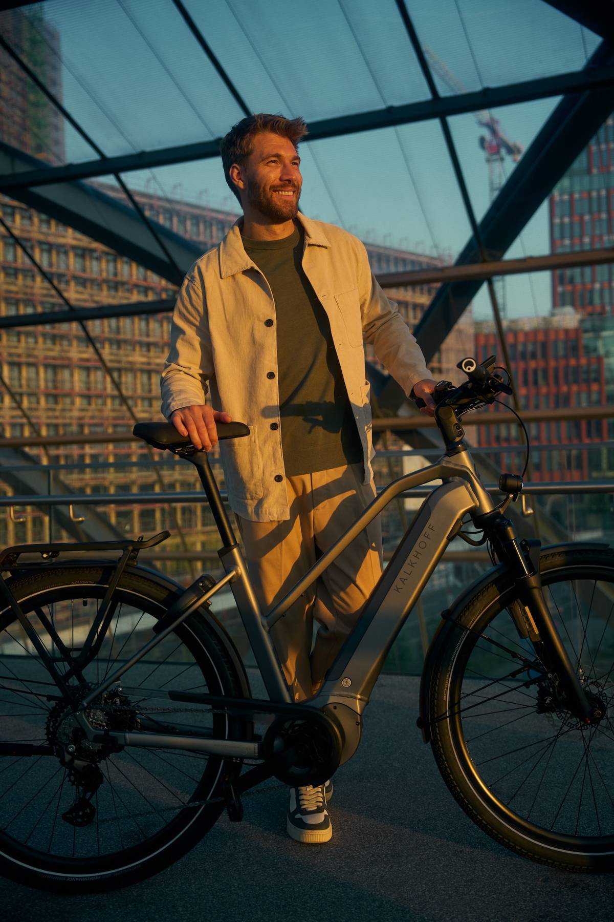 Mann steht neben Kalkhoff Fahrrad und lacht