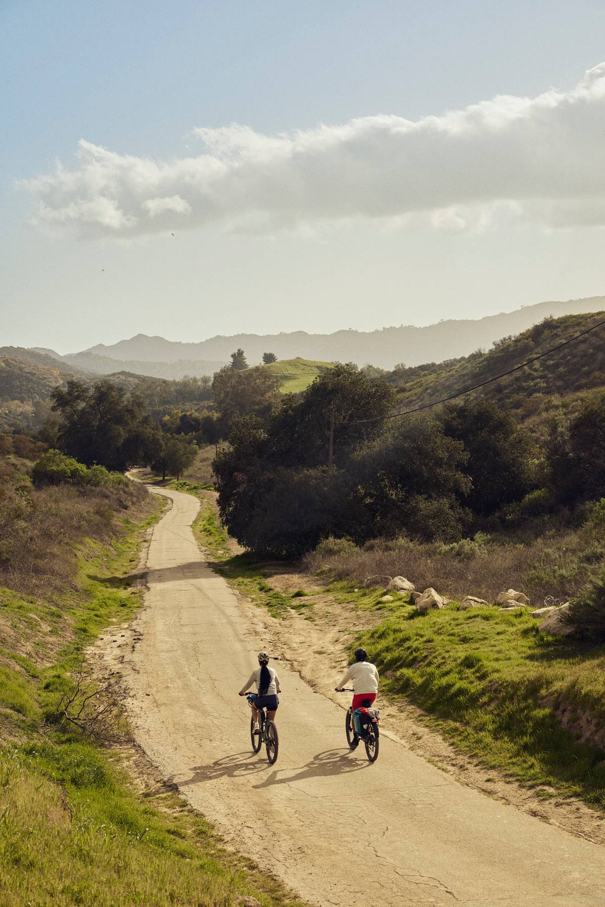 two people riding their bikes in nature