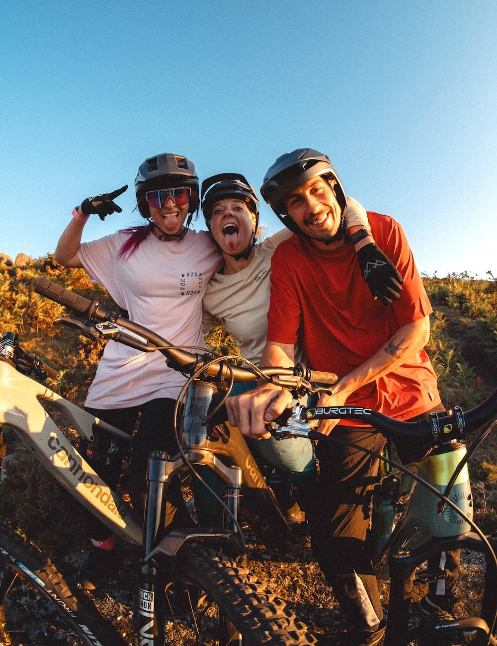 Colleagues with bikes laugh into the camera