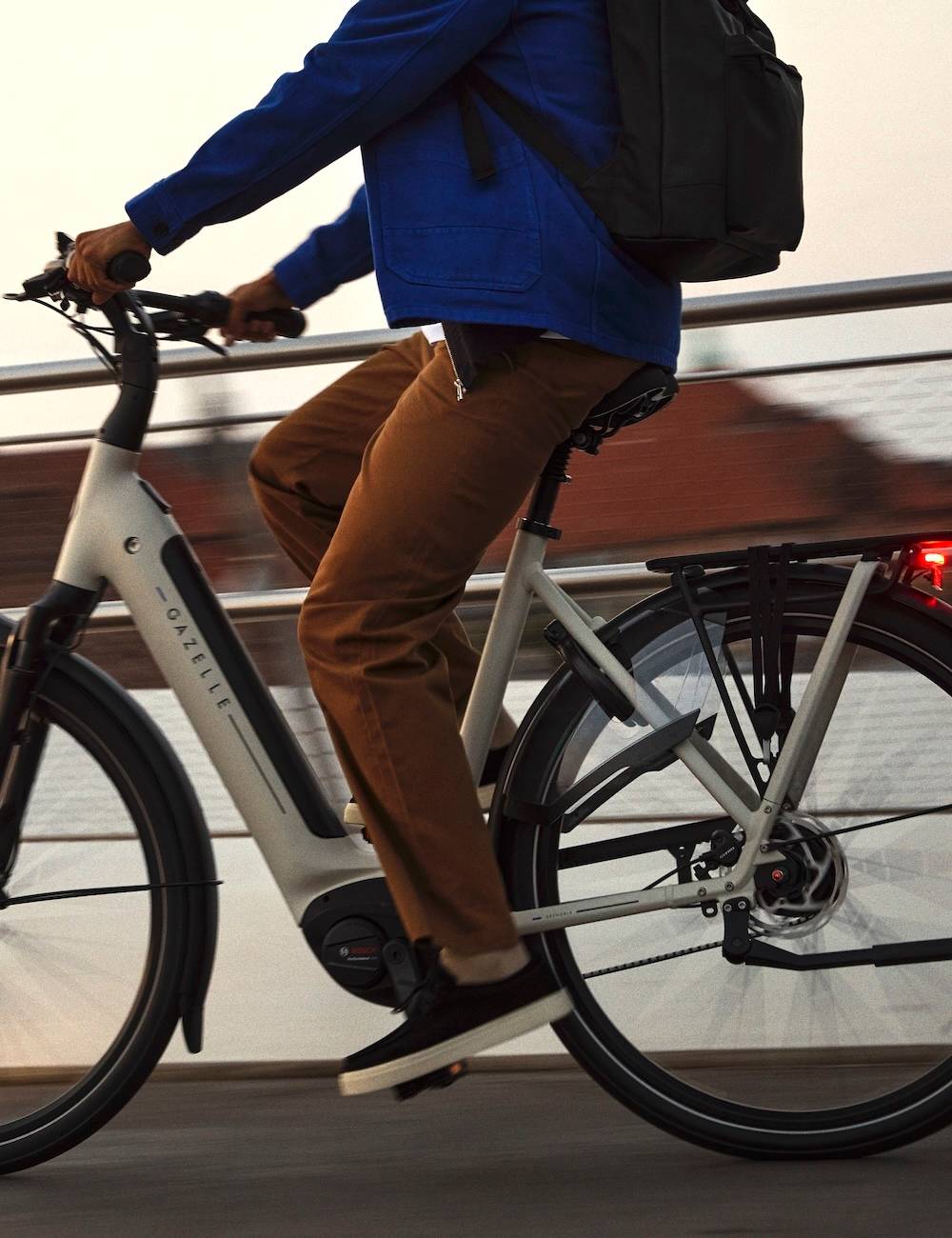 Man on e-bike on a bridge