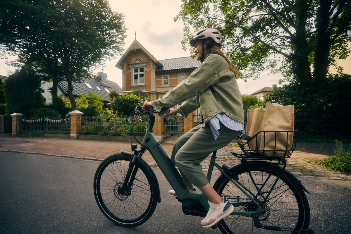 woman with Kalkhoff bike in housing area