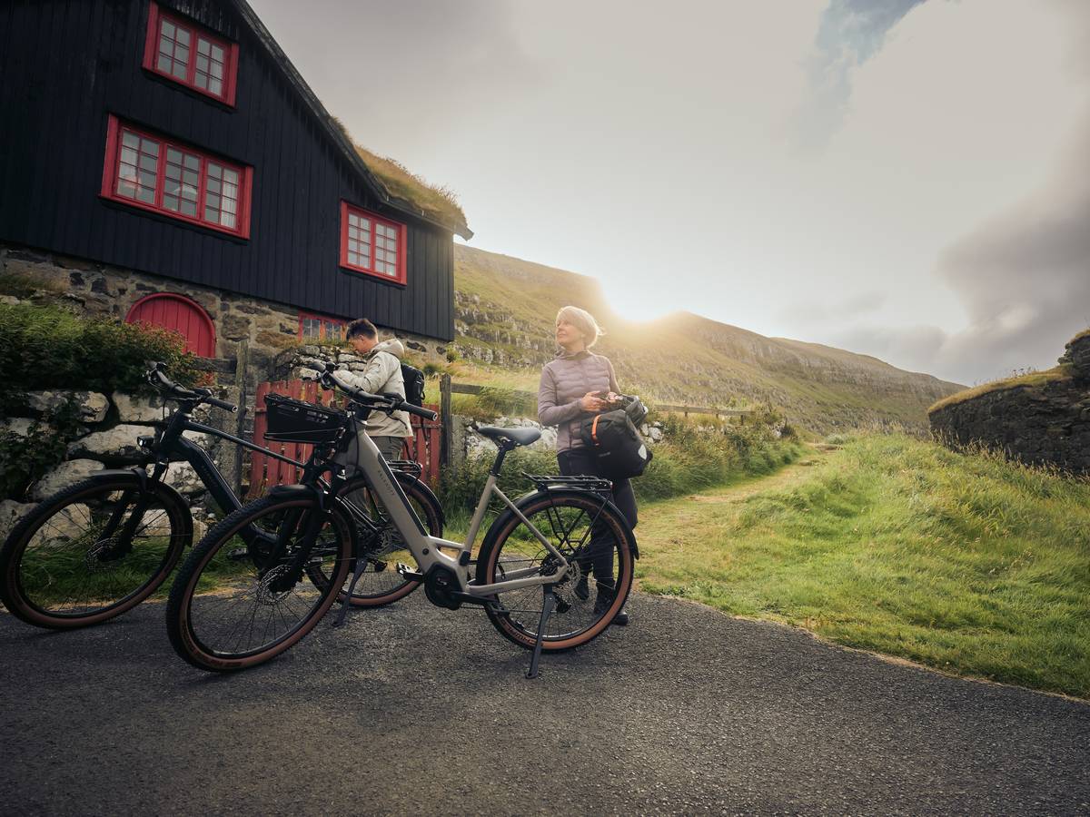 two people with bikes in mountains