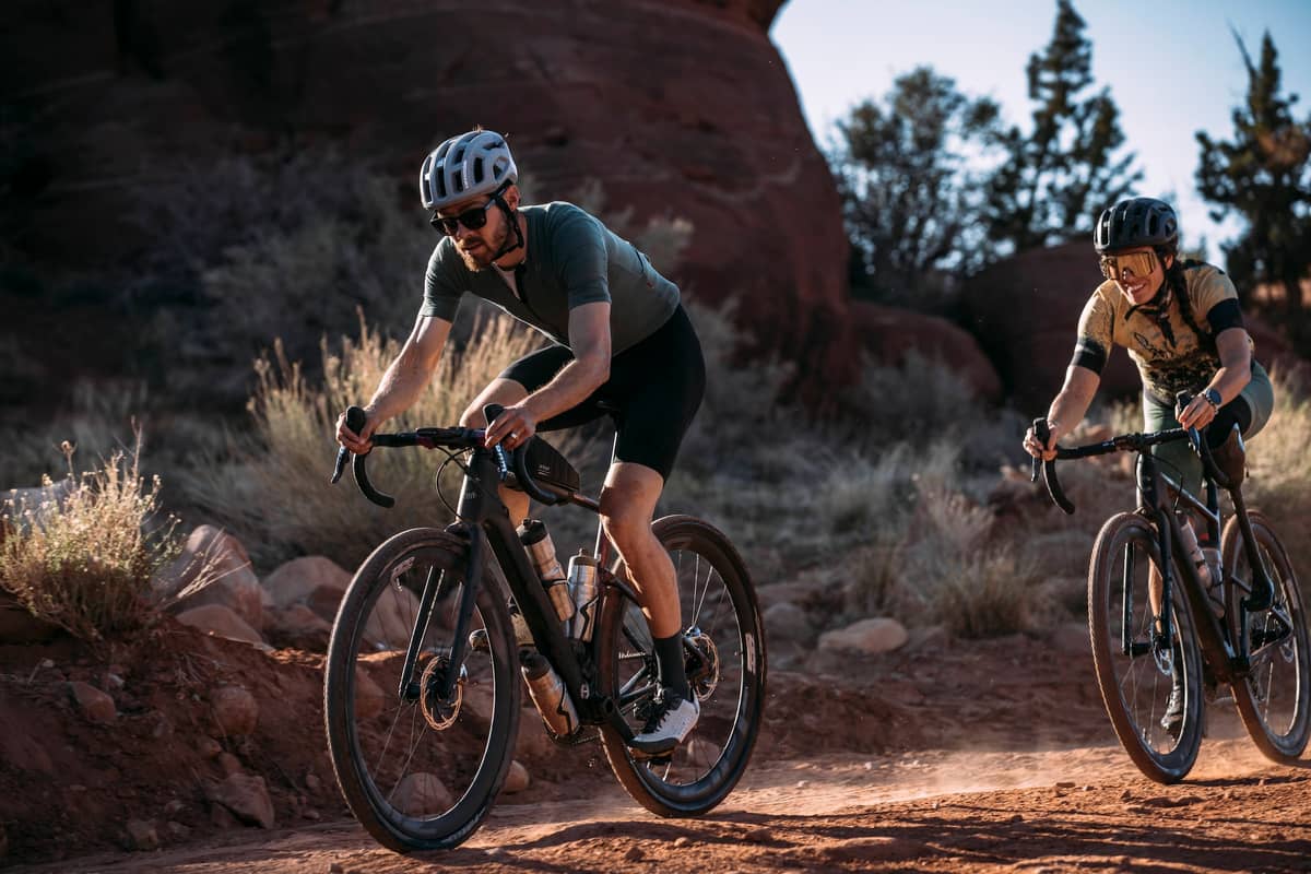 women on mountainbikes happy and giving each other high five