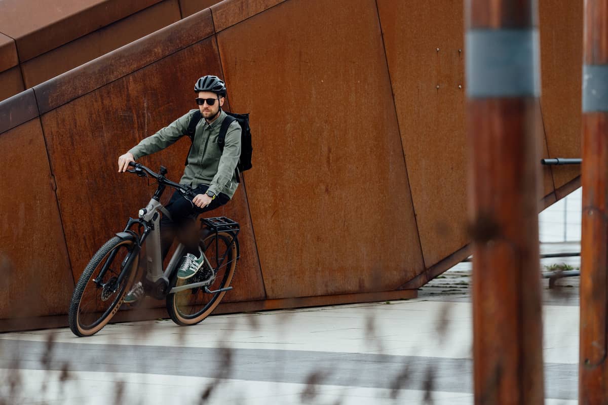 man on bike in industrial surrounding