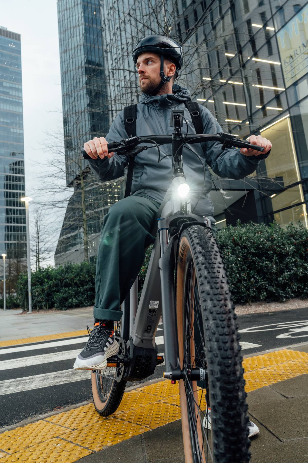 Man on Kalkhoff Bike in frotn of building